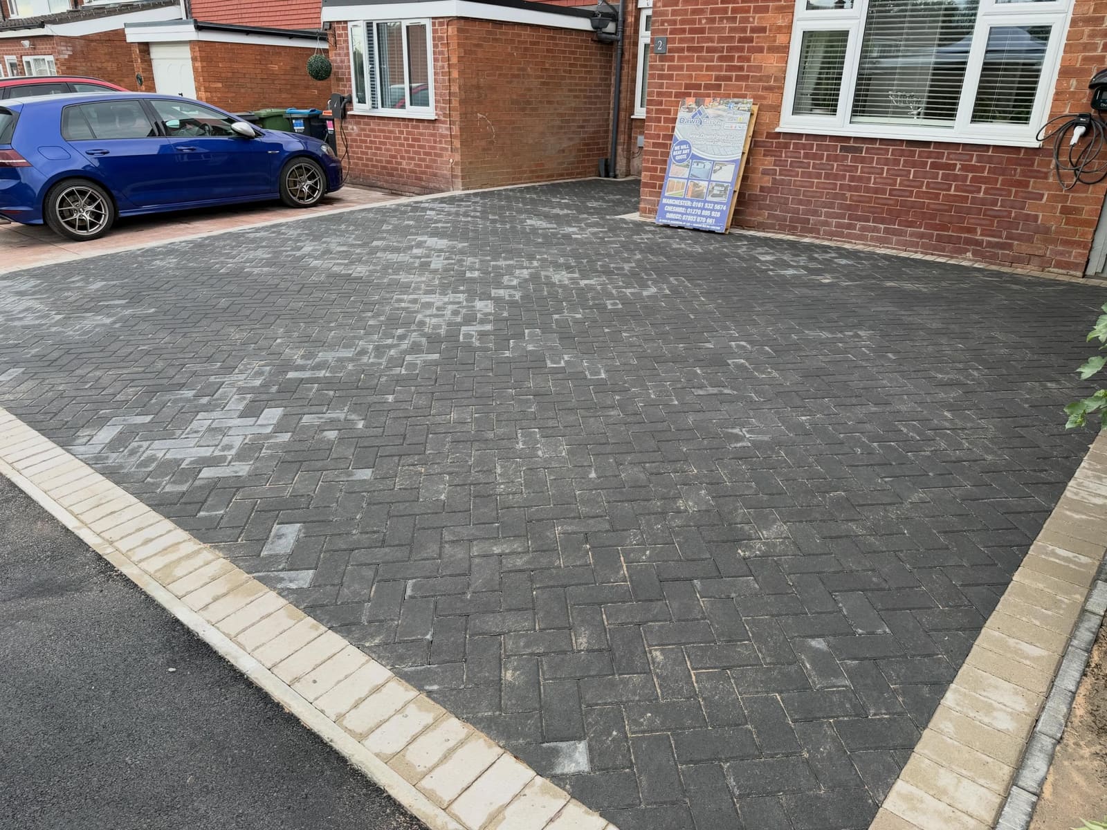 Charcoal herringbone front drive with buff soldier course border Greater Manchester