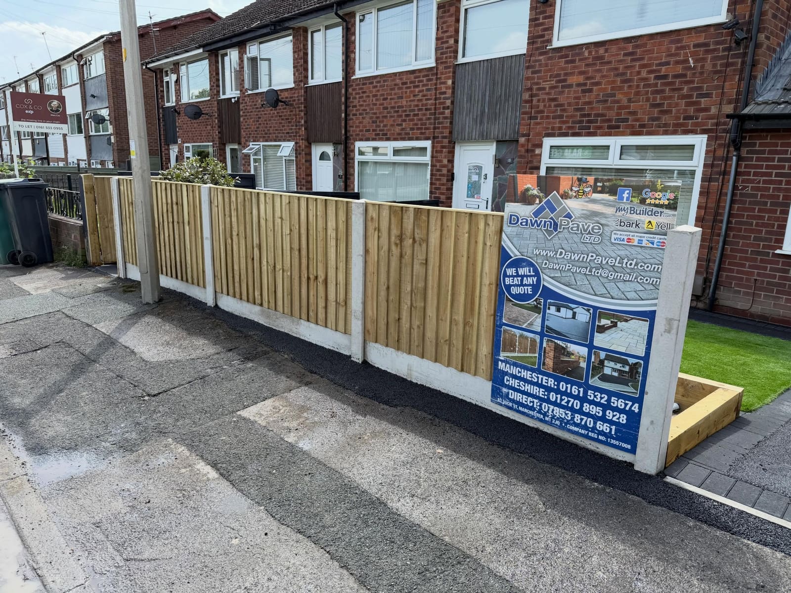 Street-facing closeboard fence on fresh tarmac with gravel boards
