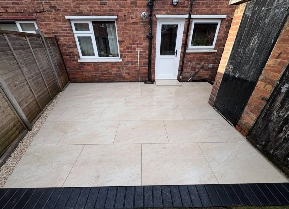 Cream porcelain rear patio with dark composite border edging Greater Manchester