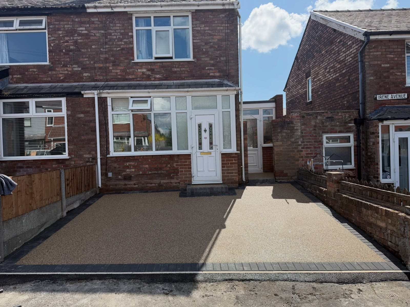 Tan resin bound front drive edged with charcoal block paving in Cheshire