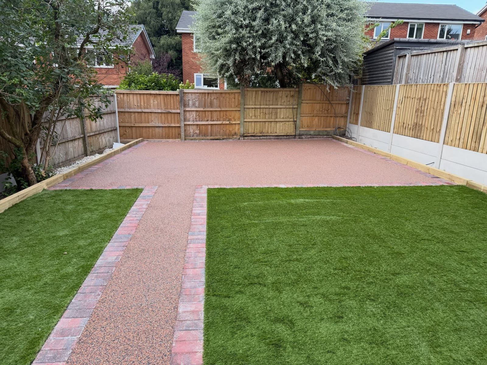 Buff resin bound rear patio path between artificial lawn beds